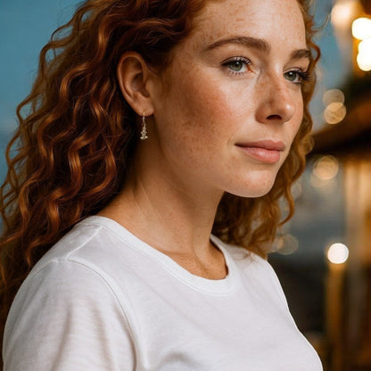 Big Blue by Roland St John bronze hammerhead shark earrings on a model with red curly hair and freckles.