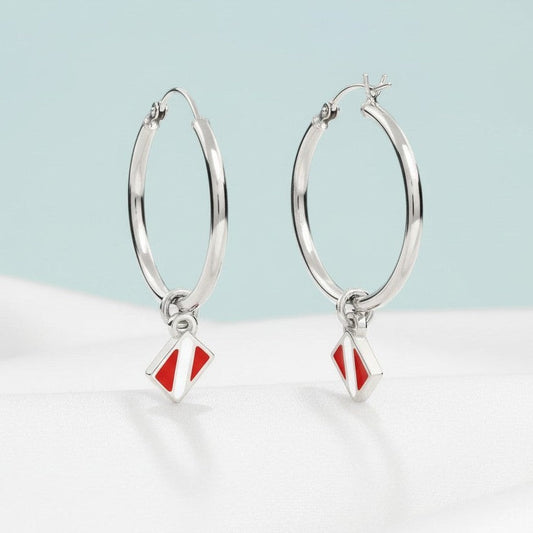 Big Blue by Roland St John sterling silver hoop earrings with red and white dive flag charms.