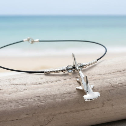 Big Blue by Roland St John sterling silver hammerhead shark choker necklace on black cable wire with blue beads.