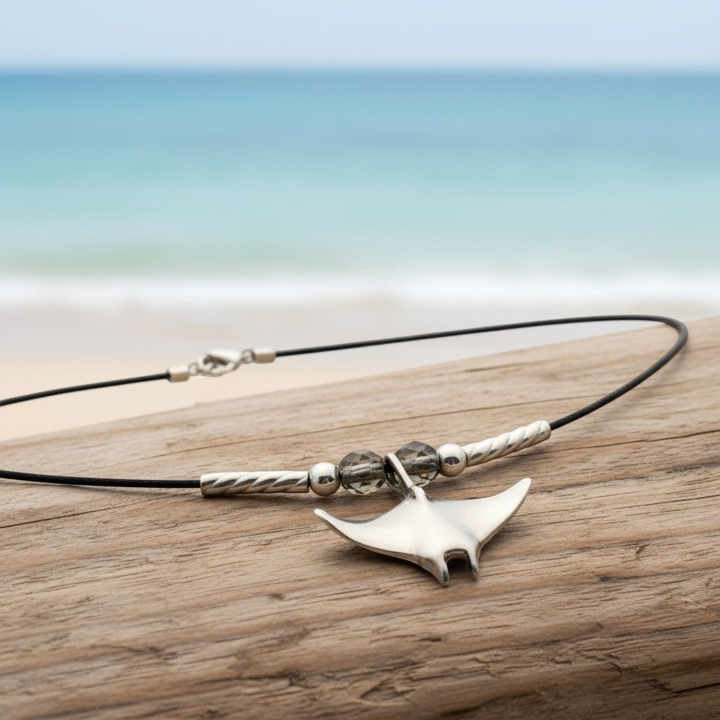 Big Blue by Roland St John sterling silver miniature manta ray choker necklace with grey beads on a black cord.