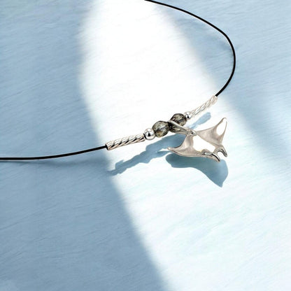 Big Blue by Roland St John sterling silver miniature manta ray choker necklace with grey beads on black cord.