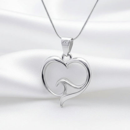 Big Blue by Roland St John sterling silver heart pendant necklace with wave detail on snake chain.