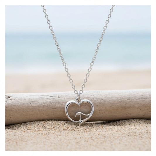 Big Blue by Roland St John sterling silver mini necklace with a heart pendant featuring an ocean wave design. Beach setting.