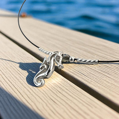 Big Blue by Roland St John sterling silver choker necklace with a miniature seahorse pendant, worn close to the neckline.