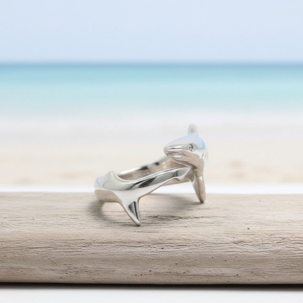 Big Blue by Roland St John sterling silver adjustable shark ring with realistic detail, set against a beach and ocean backdrop.