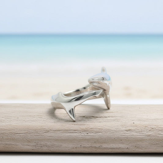 Big Blue by Roland St John sterling silver adjustable shark ring with realistic detail, set against a beach and ocean backdrop.