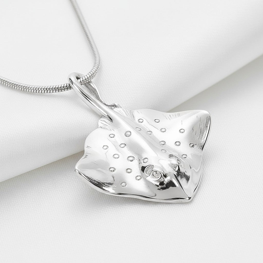 Big Blue by Roland St John sterling silver stingray pendant necklace with detailed markings and a small diamond eye, on a snake chain.