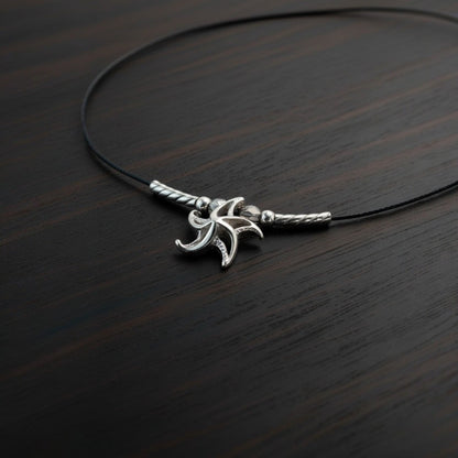 Big Blue by Roland St John sterling silver choker necklace with a miniature 3D starfish pendant, featuring a black cord and silver accents.