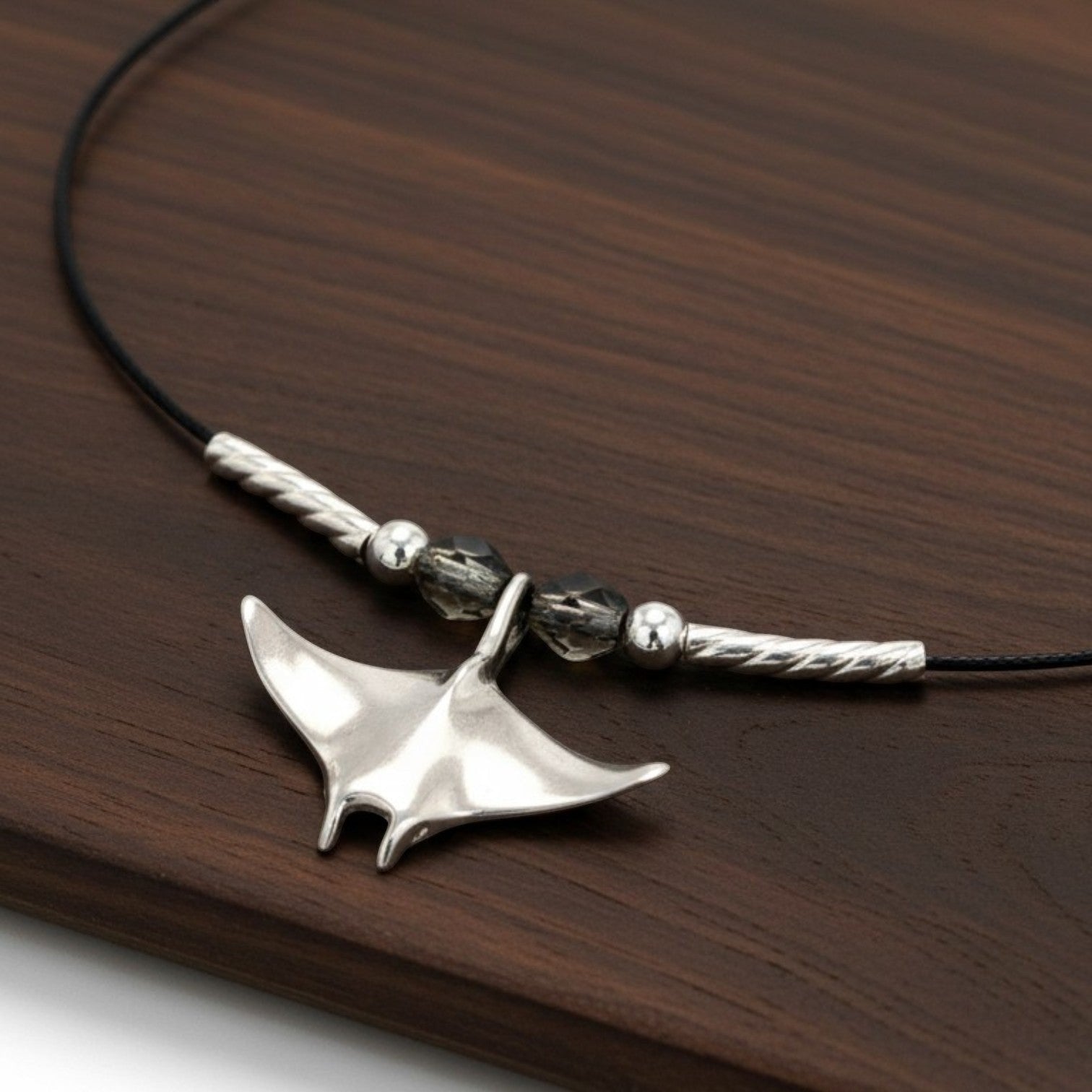 Big Blue by Roland St John sterling silver miniature manta ray choker necklace with black cord and crystal beads.