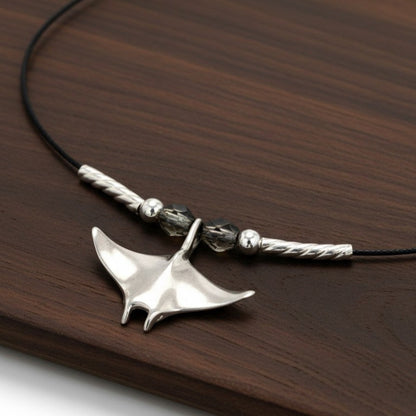 Big Blue by Roland St John sterling silver miniature manta ray choker necklace with black cord and crystal beads.