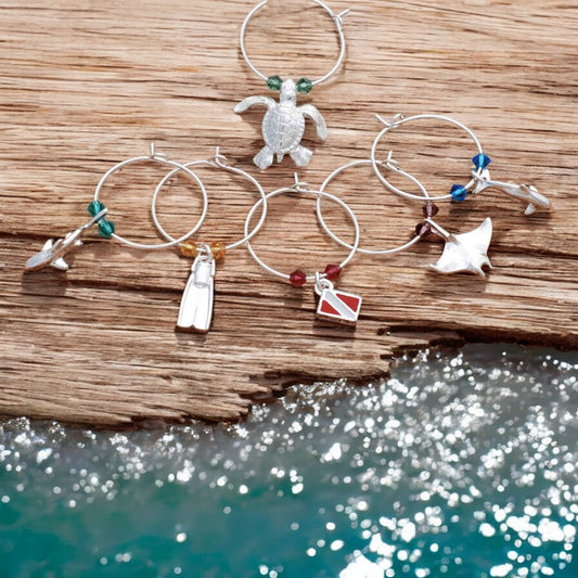 Big Blue by Roland St John set of 6 diver-themed wine glass charms with pewter turtle, dive fin, manta ray, shark, dolphin, and dive flag, accented with colorful beads.