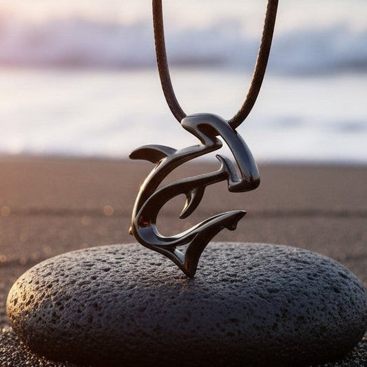 Big Blue by Roland St John "The Hammer" pendant necklace, jet black finish, hammerhead shark design on a dark stone at the beach.