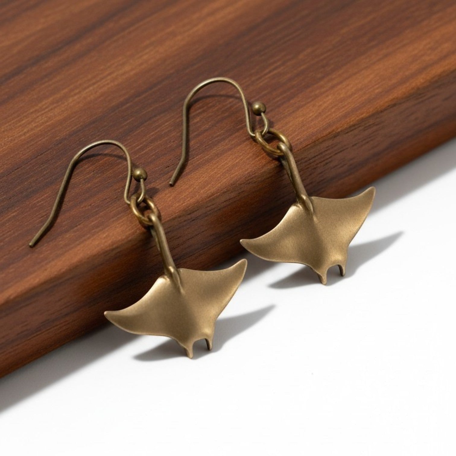 Big Blue by Roland St John bronze manta ray drop earrings, part of the Sealife Collection. Sculpted in bronze with a warm, earthy tone.