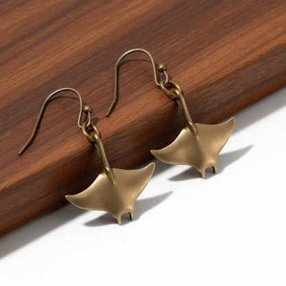 Big Blue by Roland St John bronze manta ray drop earrings, part of the Sealife Collection. Sculpted in bronze with a warm, earthy tone.