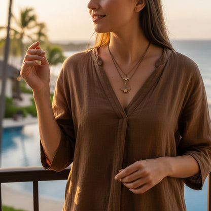 Big Blue by Roland St John layered bronze manta ray necklace with two pendants on a model wearing a brown dress.