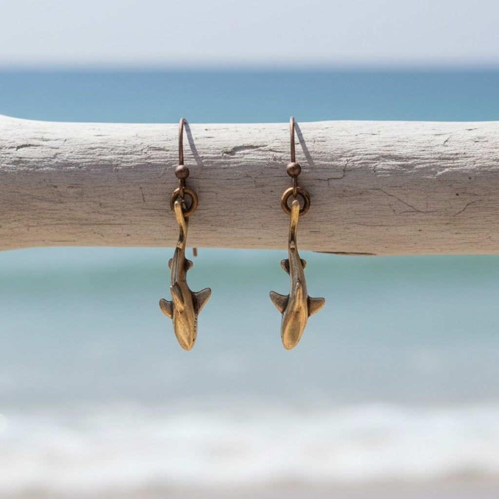 Big Blue by Roland St John bronze shark drop earrings with realistic detail, hanging from French hooks.