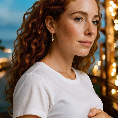 Big Blue by Roland St John bronze shark drop earrings on a model with red curly hair.