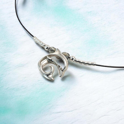 Big Blue by Roland St John sterling silver choker necklace with a miniature dolphin pendant. Black cord with silver accents.