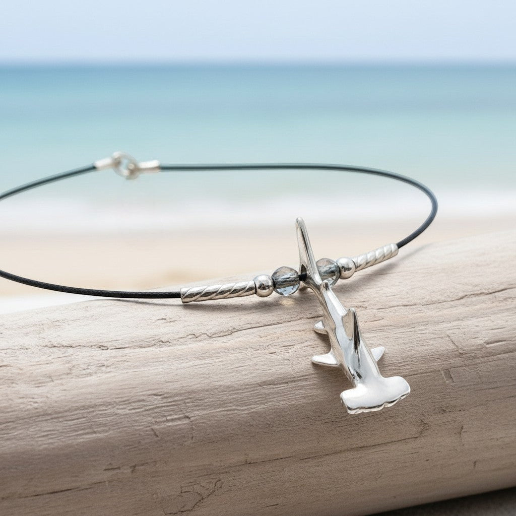 Big Blue by Roland St John sterling silver hammerhead shark choker necklace with blue beads on black cable wire.