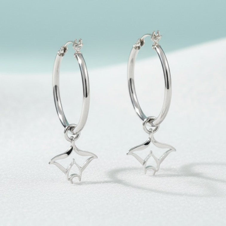 Big Blue by Roland St John sterling silver hoop earrings with detailed manta ray charms. Polished finish, 1.5" long.