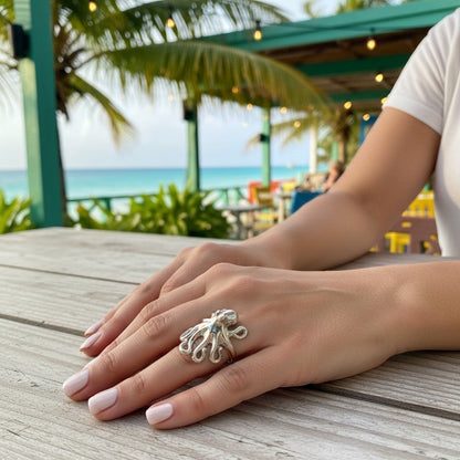 Big Blue by Roland St John sterling silver octopus ring on a woman's finger, adjustable, detailed tentacles.