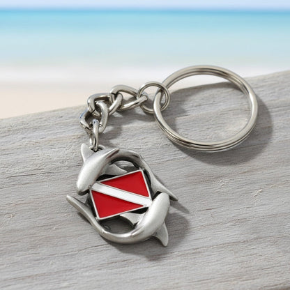 Big Blue by Roland St John pewter keychain with two sharks circling a red and white dive flag. Features a detailed 3D design and a silver keyring.