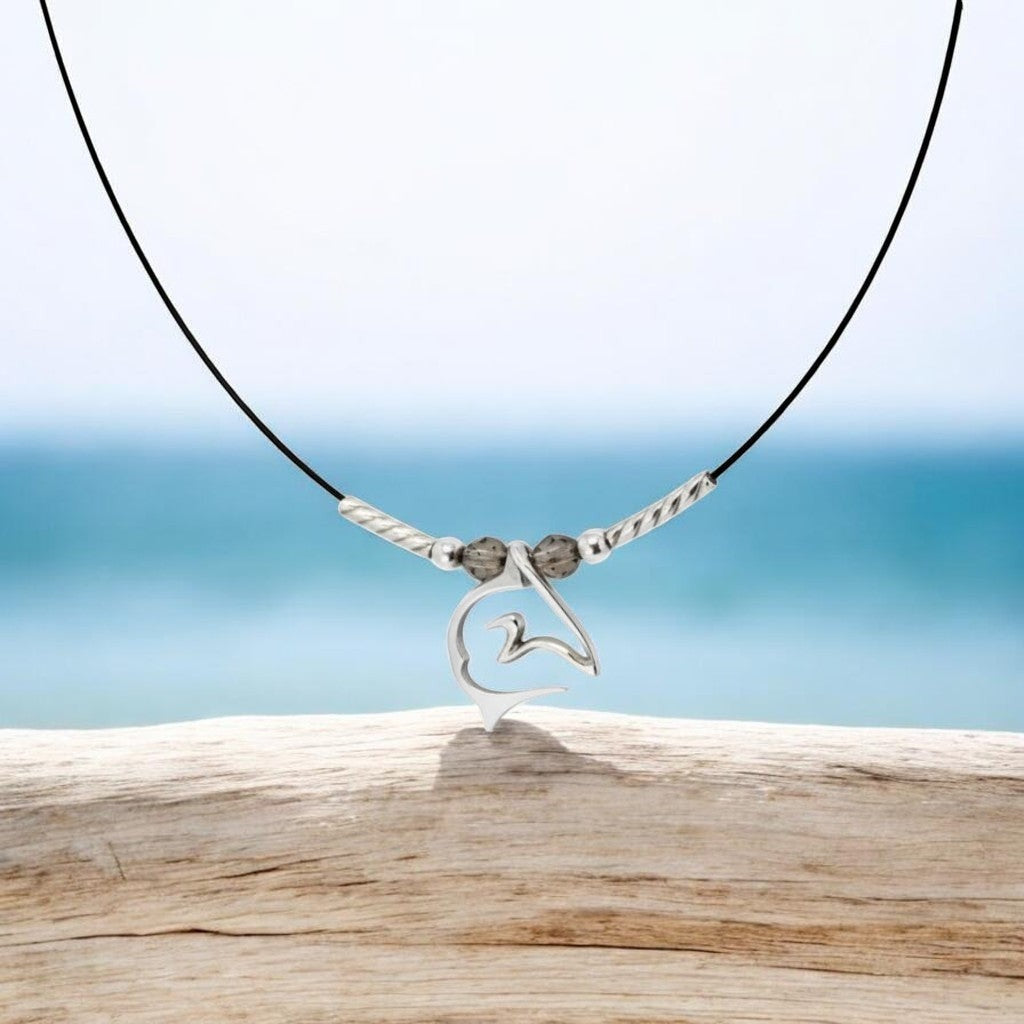 Big Blue by Roland St John sterling silver shark pendant necklace on black cable wire with grey beads.