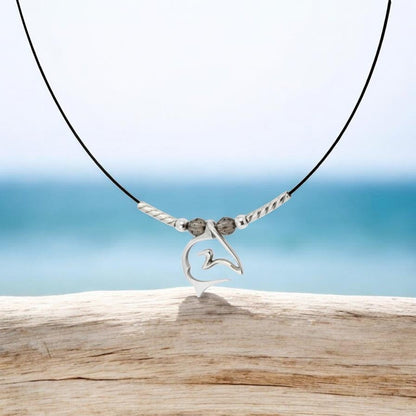 Big Blue by Roland St John sterling silver shark pendant necklace on black cable wire with grey beads.
