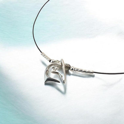 Big Blue by Roland St John sterling silver shark pendant necklace on black cable wire with silver accents.