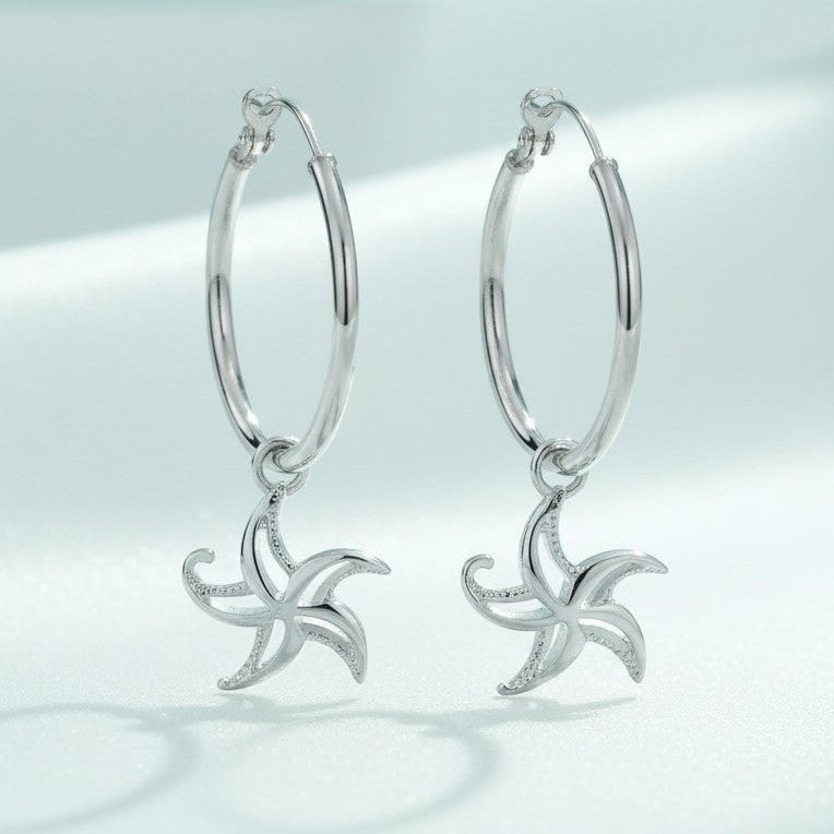 Big Blue by Roland St John sterling silver hoop earrings with dangling starfish charms, 1.5" tall.
