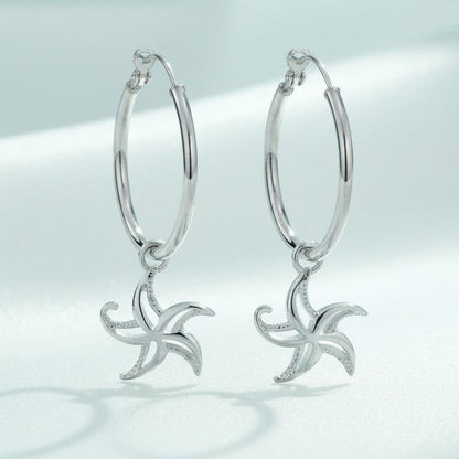 Big Blue by Roland St John sterling silver hoop earrings with dangling starfish charms, 1.5" tall.