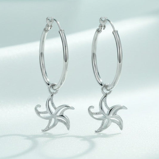Big Blue by Roland St John sterling silver hoop earrings with dangling starfish charms, 1.5" tall.