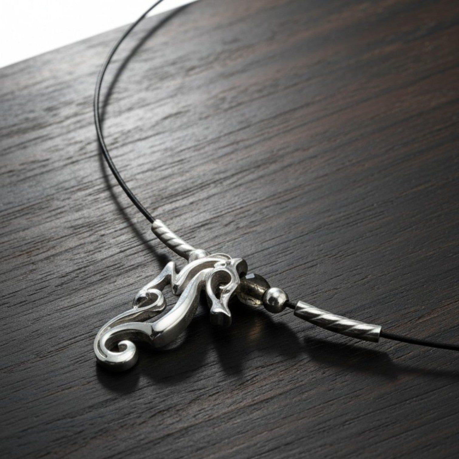 Big Blue by Roland St John sterling silver choker necklace with a miniature seahorse pendant, worn close to the neckline.