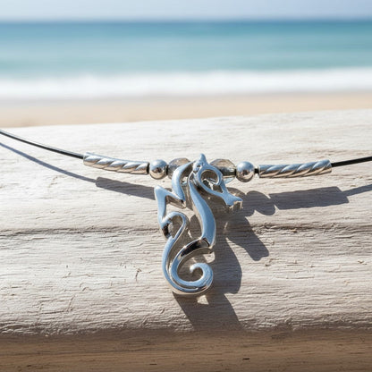 Big Blue by Roland St John sterling silver choker necklace with a miniature seahorse pendant, worn close to the neckline.