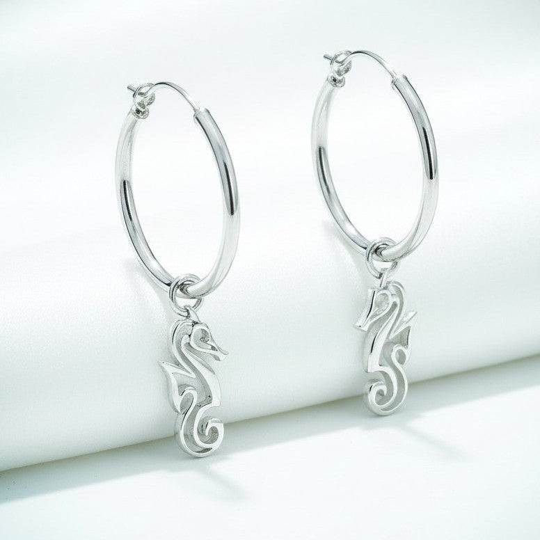 Big Blue by Roland St John sterling silver hoop earrings with dangling seahorse charms. Modern ocean-inspired design.